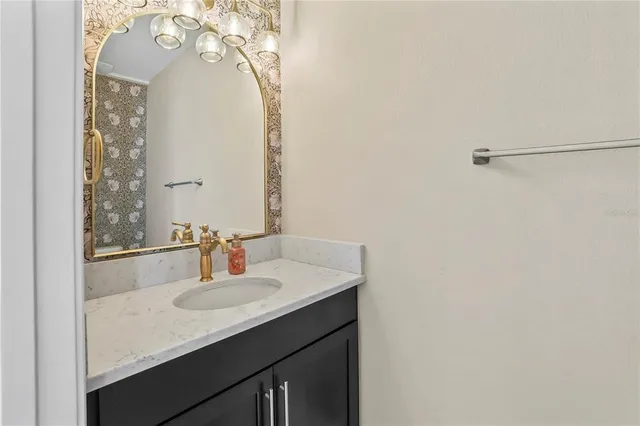 a bathroom with a sink vanity and a mirror