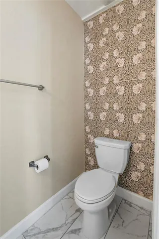 a white toilet sitting next to a shower curtain