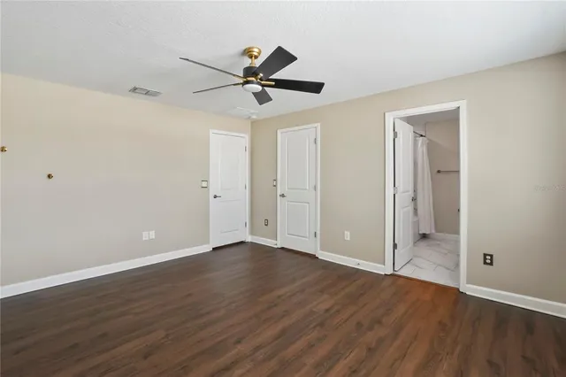 a view of an empty room and wooden floor
