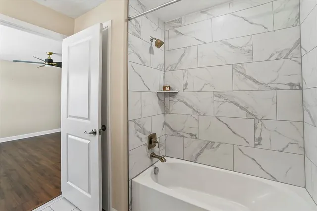 a bathroom with a bathtub and shower