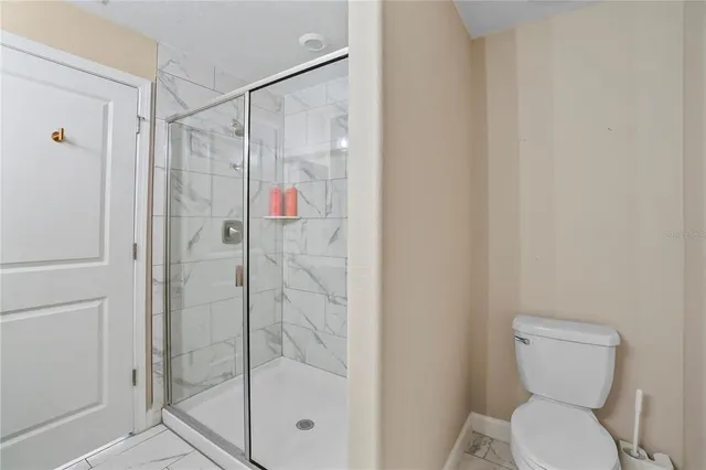 a bathroom with a shower and toilet