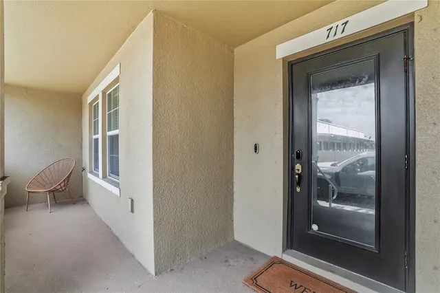 a view of a hallway with wooden floor and a living room