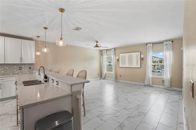 a kitchen with stainless steel appliances granite countertop a sink and a refrigerator