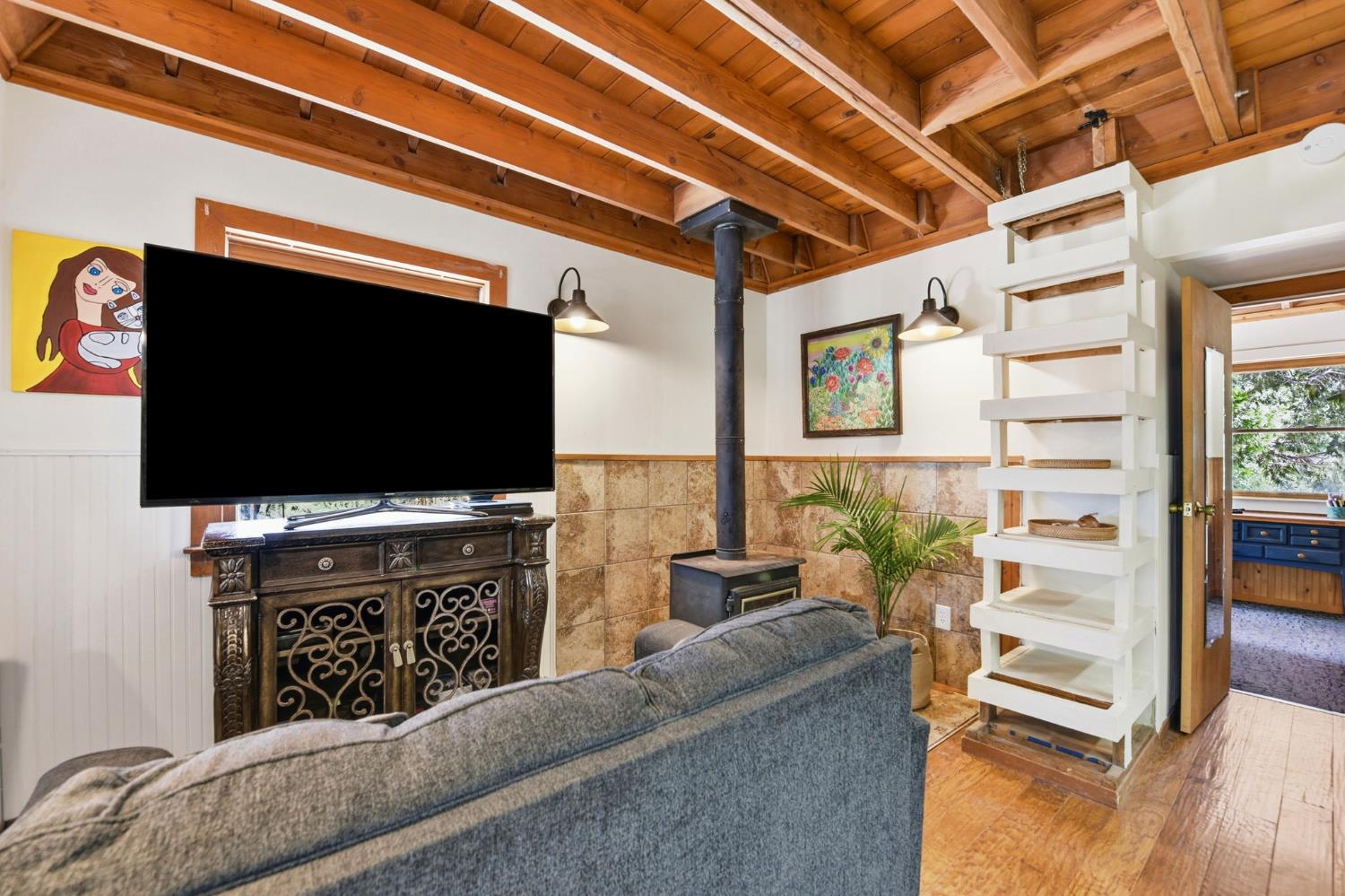 7201 Happy Valley Road Somerset, CA 95684 - Photo 51 of 75 There is a perfectly sized wood burning stove for heat, and a built-in ladder that allows access to the art studio above or shelves for books or to display your treasures.
