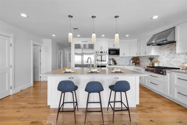 a kitchen with cabinets and stainless steel appliances