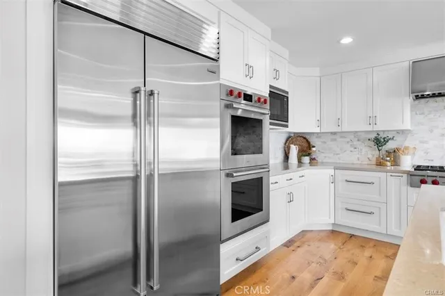 a kitchen with kitchen island granite countertop a sink a center island and stainless steel appliances