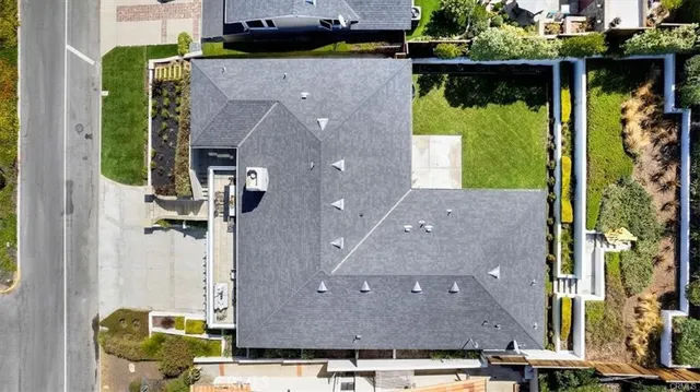 a aerial view of a house with a yard and sitting area