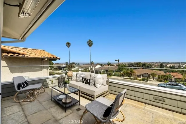 a view of a patio with table and chairs with wooden floor and fence