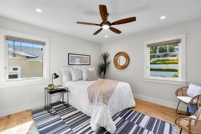 a living room with furniture a clock and a potted plant