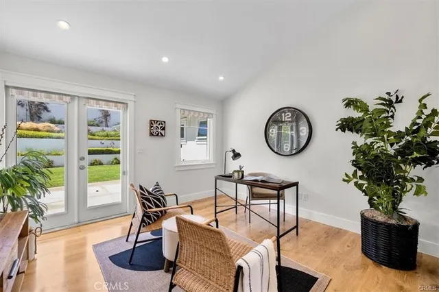 a living room with lots of furniture and a view of kitchen