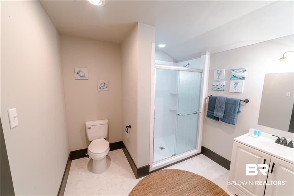207 Michigan Avenue Mobile, AL 36604 - Photo 27 of 31 Bathroom featuring a stall shower, vanity, lofted ceiling, and recessed lighting