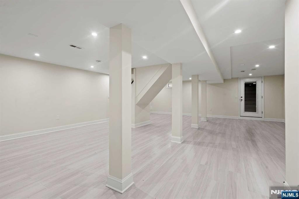 238 Springfield Avenue, Unit 1 Rutherford, NJ 07070 - Photo 14 of 33 an empty room with wooden floor and windows