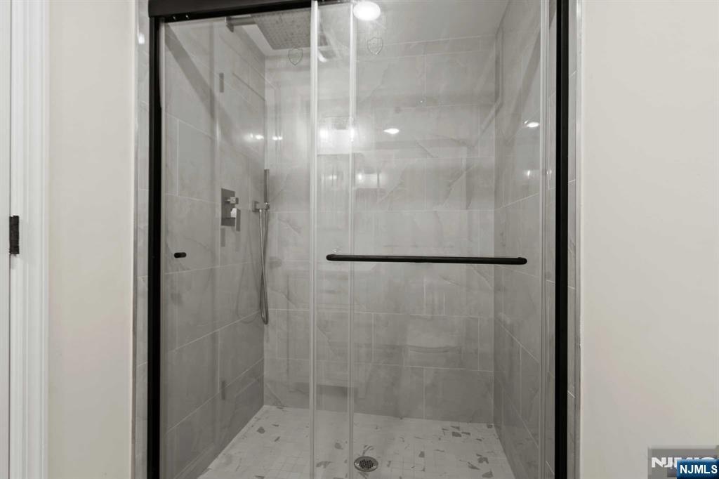 238 Springfield Avenue, Unit 1 Rutherford, NJ 07070 - Photo 18 of 33 a bathroom with a glass shower door