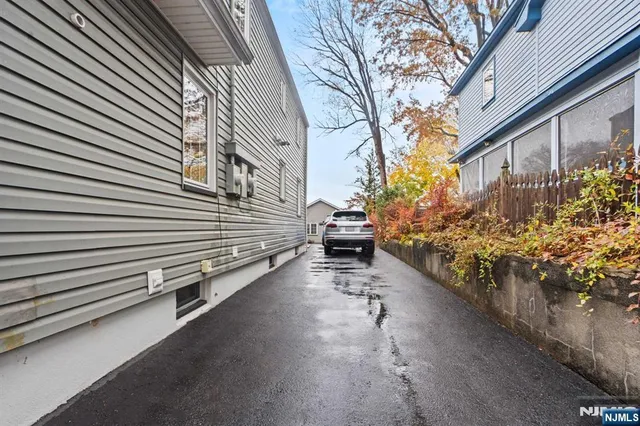 a view of a house with a yard and a street