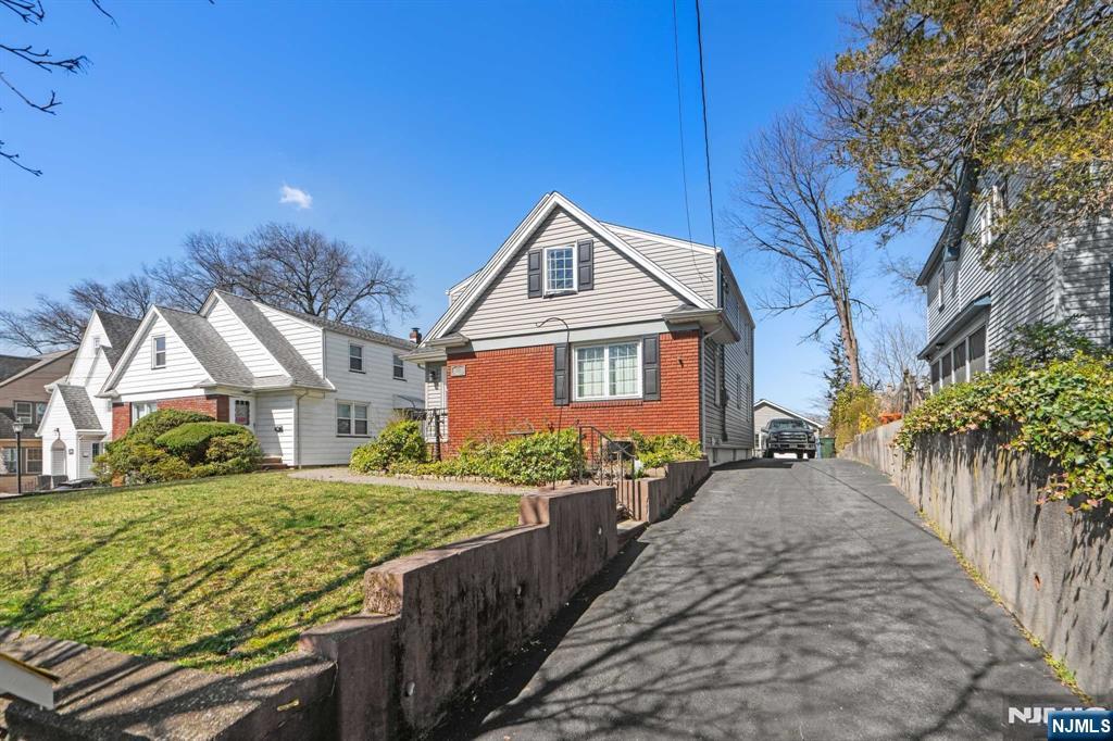 238 Springfield Avenue, Unit 1 Rutherford, NJ 07070 - Photo 26 of 33 a front view of a house with garden
