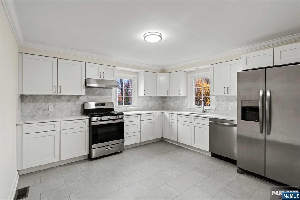 238 Springfield Avenue, Unit 1 Rutherford, NJ 07070 - Photo 7 of 33 a kitchen with a refrigerator stove top oven and sink