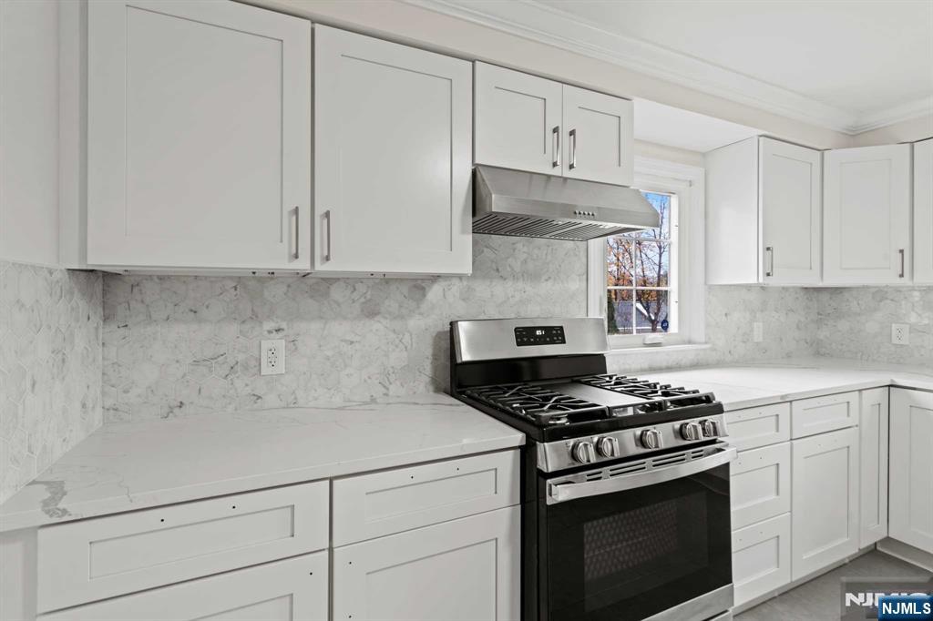 238 Springfield Avenue, Unit 1 Rutherford, NJ 07070 - Photo 9 of 33 a kitchen with white cabinets and appliances