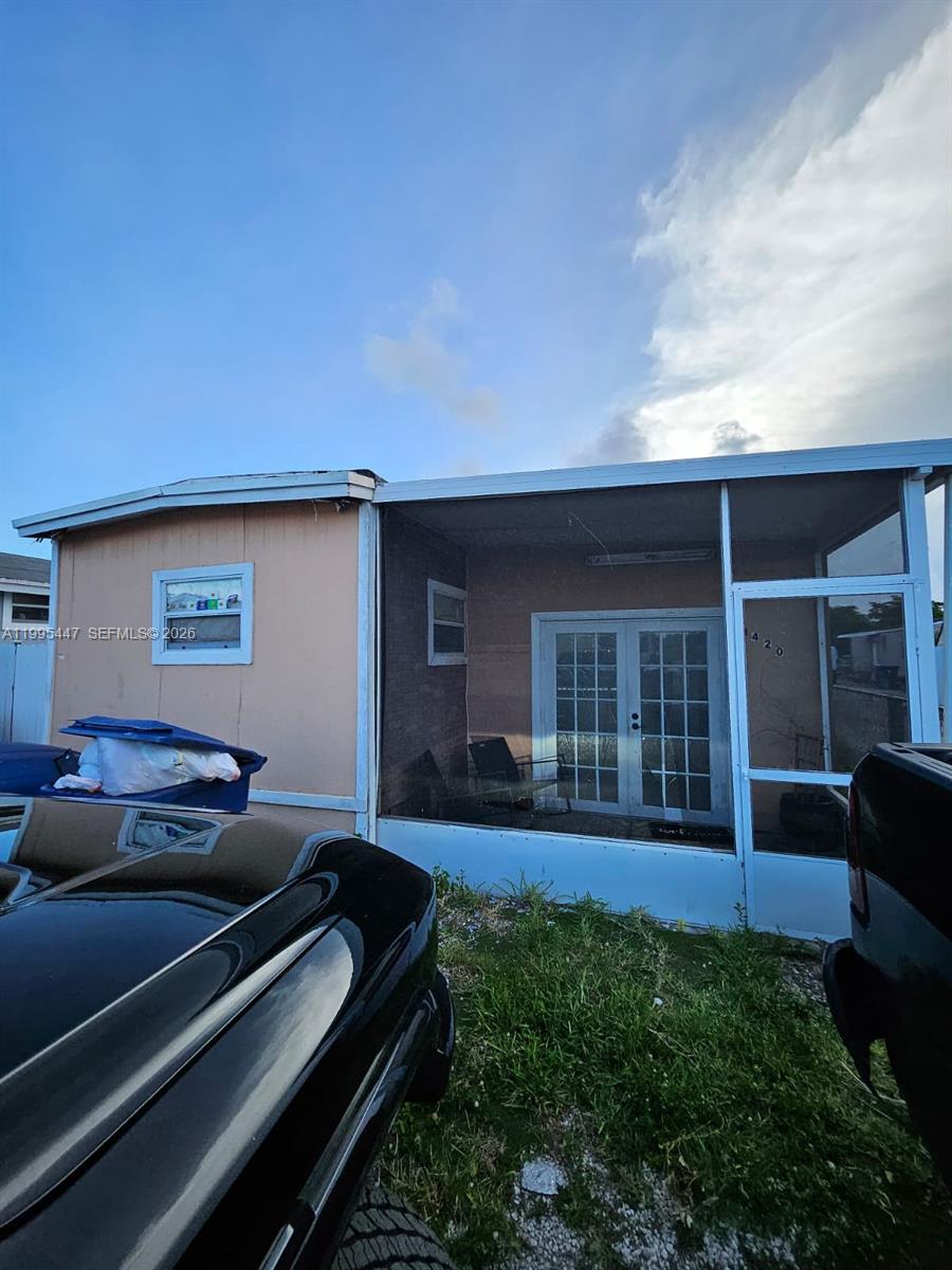 1420 Southwest 129th Court, Unit 1 Miami, FL 33184 - Photo 1 of 11 a backyard of a house with seating space