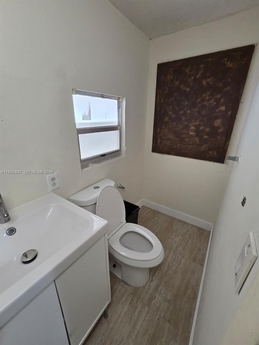 1420 Southwest 129th Court, Unit 1 Miami, FL 33184 - Photo 11 of 11 a bathroom with a toilet a sink and mirror