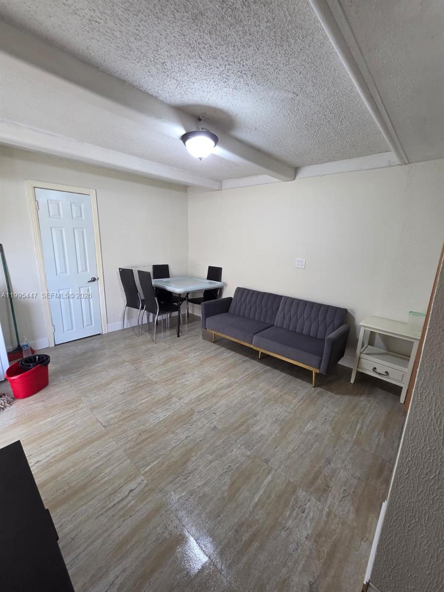 1420 Southwest 129th Court, Unit 1 Miami, FL 33184 - Photo 4 of 11 a living room with furniture and a dining table
