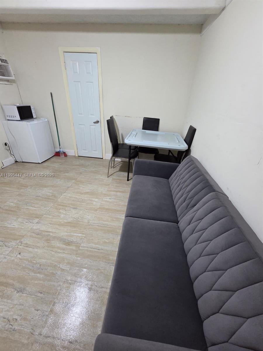 1420 Southwest 129th Court, Unit 1 Miami, FL 33184 - Photo 5 of 11 a living room with furniture and a rug