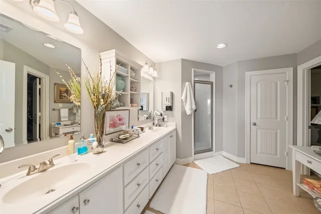 a spacious bathroom with a double vanity sink mirror and double