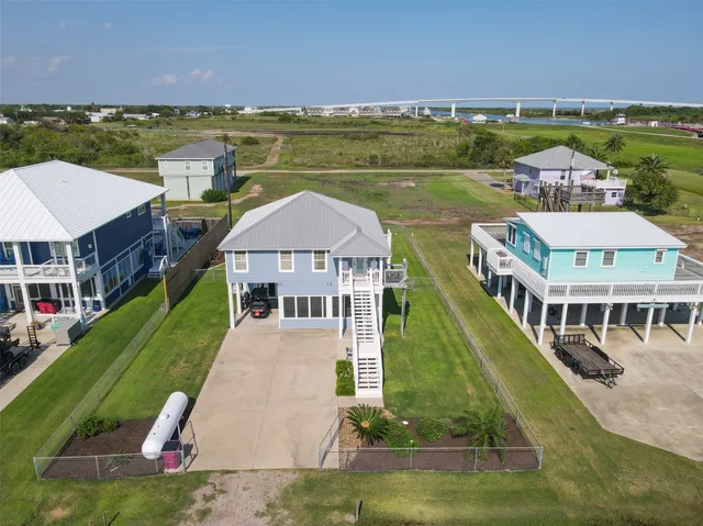 an aerial view of a house with a garden and lake view