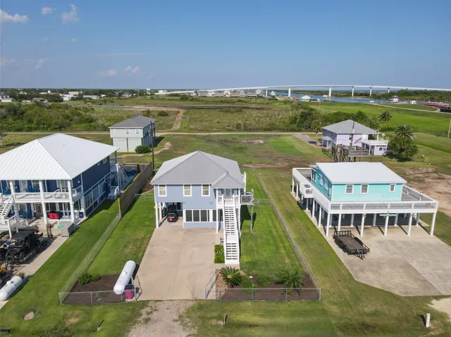 an aerial view of a house with a garden and lake view