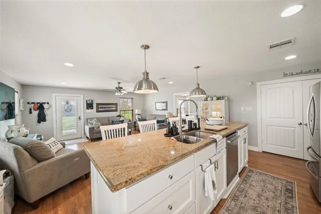 a view of a kitchen center island and living room