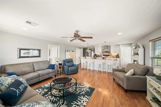 a living room with furniture and wooden floor