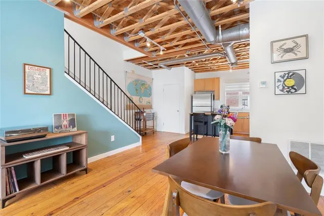 a dining room with furniture and wooden floor
