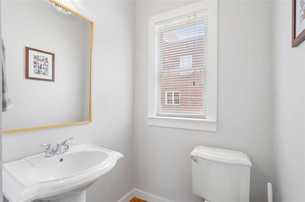 322 Peters Street Southwest, Unit 2 Atlanta, GA 30313 - Photo 20 of 58 a bathroom with a sink a toilet and a mirror