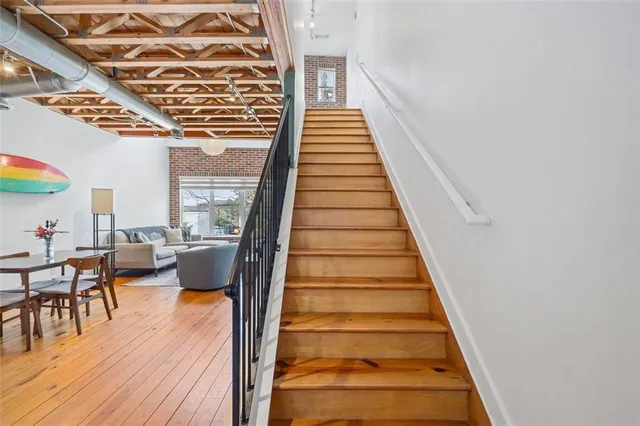 a view of a bedroom with wooden floor