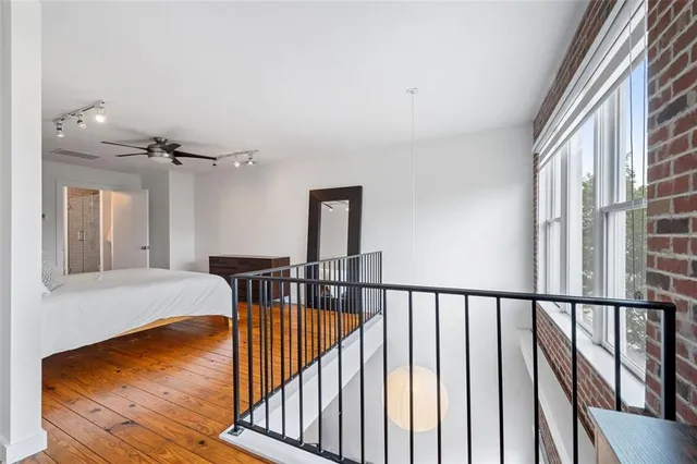 a bedroom with a bed and a ceiling fan