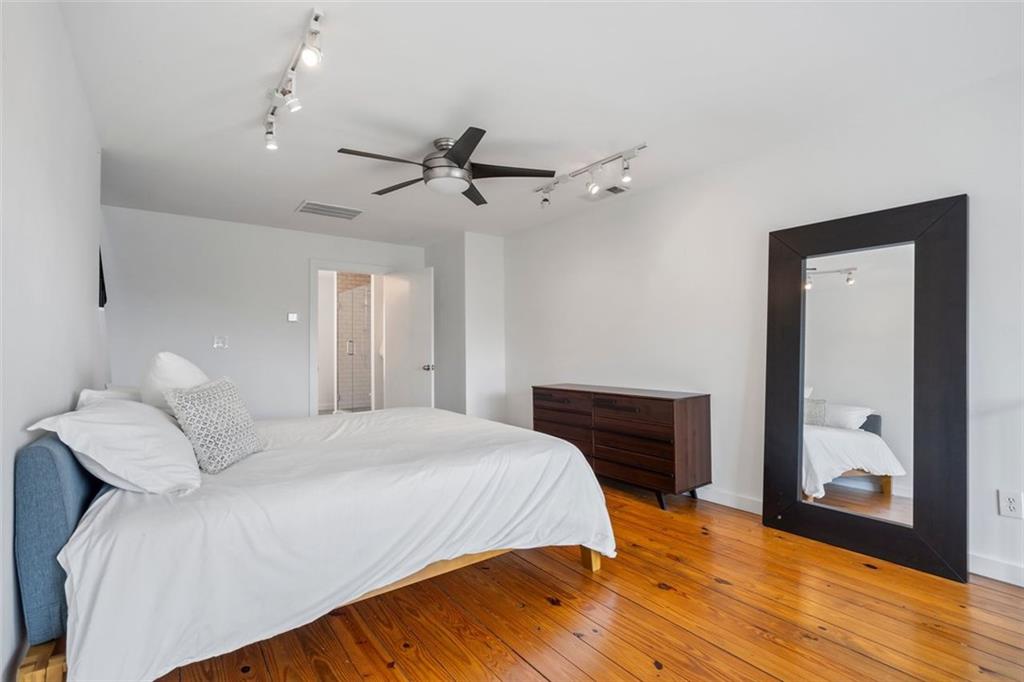 322 Peters Street Southwest, Unit 2 Atlanta, GA 30313 - Photo 25 of 58 a bedroom with a bed and wooden floor