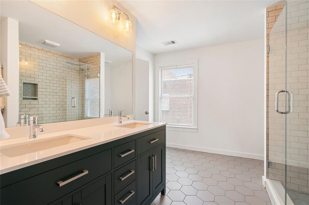 322 Peters Street Southwest, Unit 2 Atlanta, GA 30313 - Photo 28 of 58 a bathroom with a granite countertop sink and a mirror