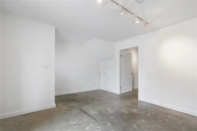 a front view of a building with a parking area