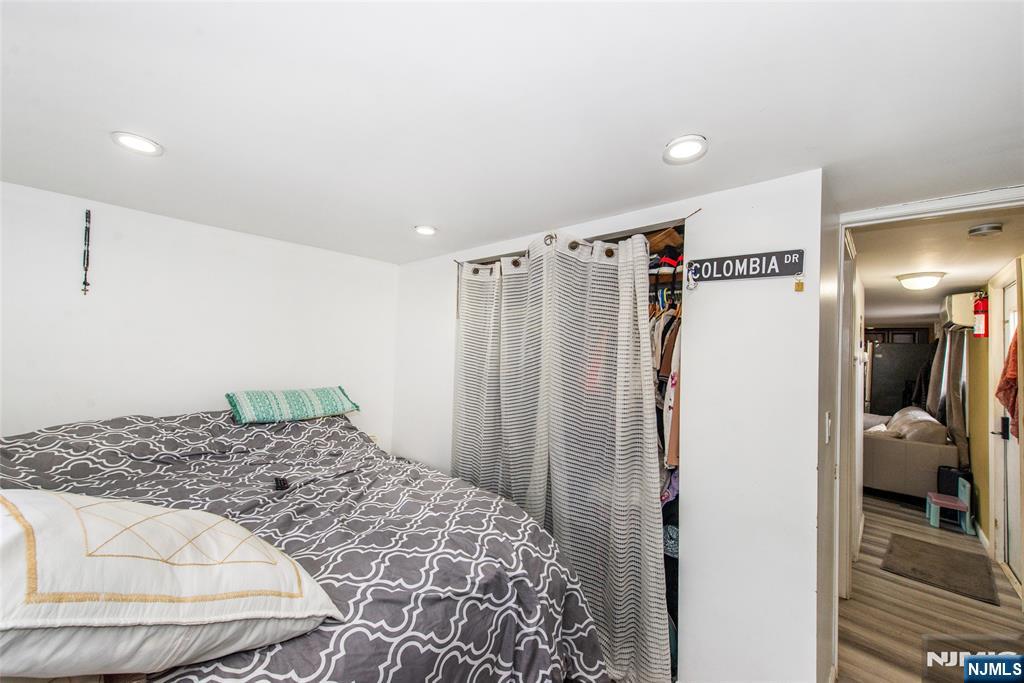 39 Helen Drive Moonachie, NJ 07074 - Photo 16 of 20 a bedroom with a bed and a refrigerator