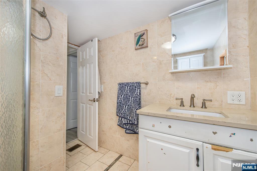 39 Helen Drive Moonachie, NJ 07074 - Photo 18 of 20 a bathroom with a sink a toilet and shower