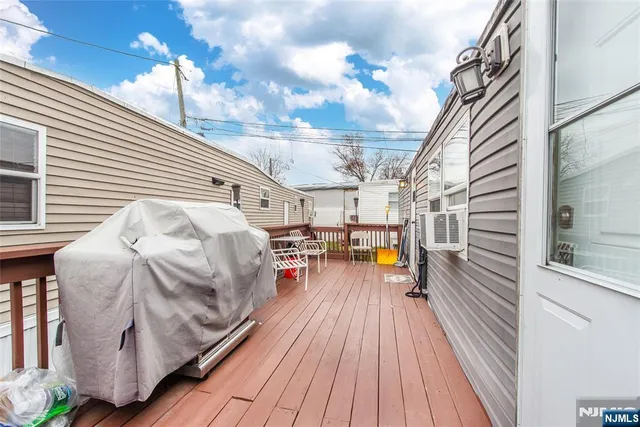 a roof deck with wooden floor and cabinets