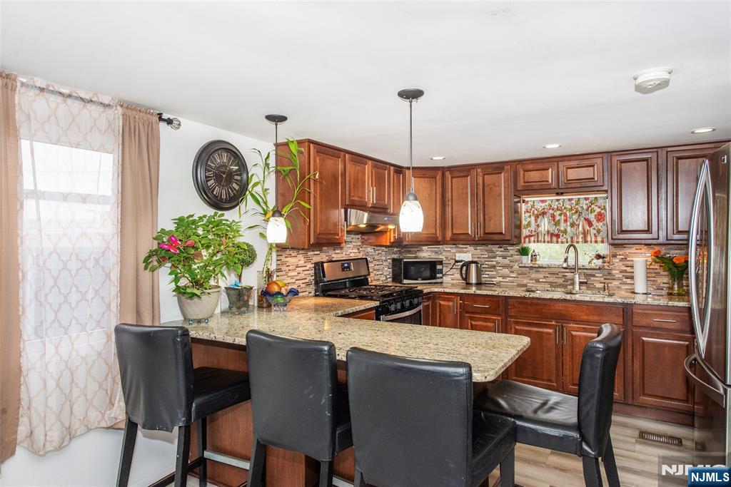 39 Helen Drive Moonachie, NJ 07074 - Photo 9 of 20 a kitchen with a table and chairs in it