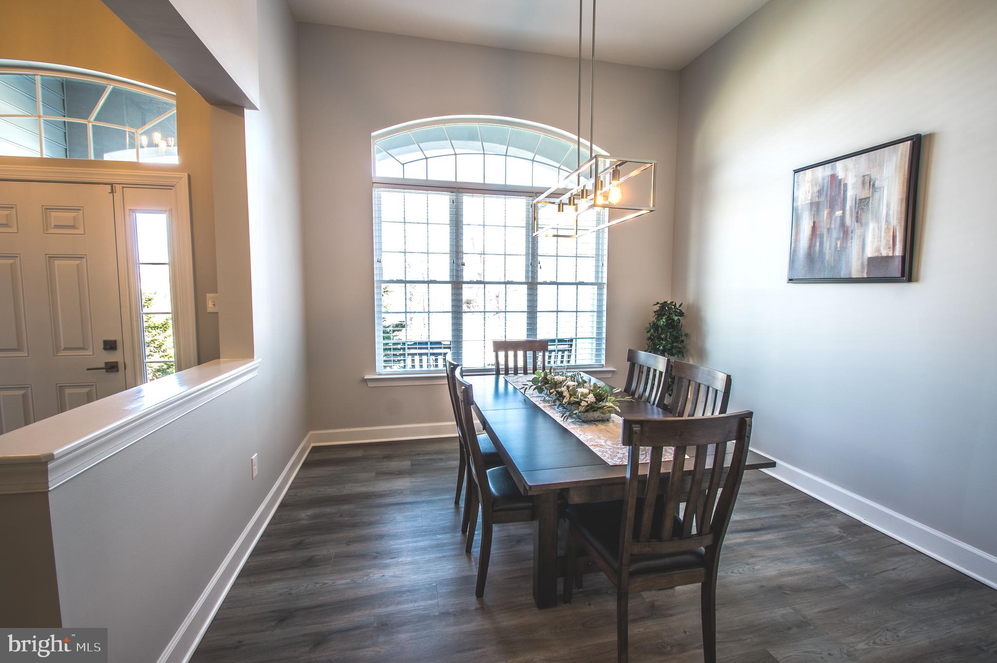 105 Quartz Ridge Road Hanover, PA 17331 - Photo 20 of 51 a view of a dining room with furniture a chandelier and wooden floor