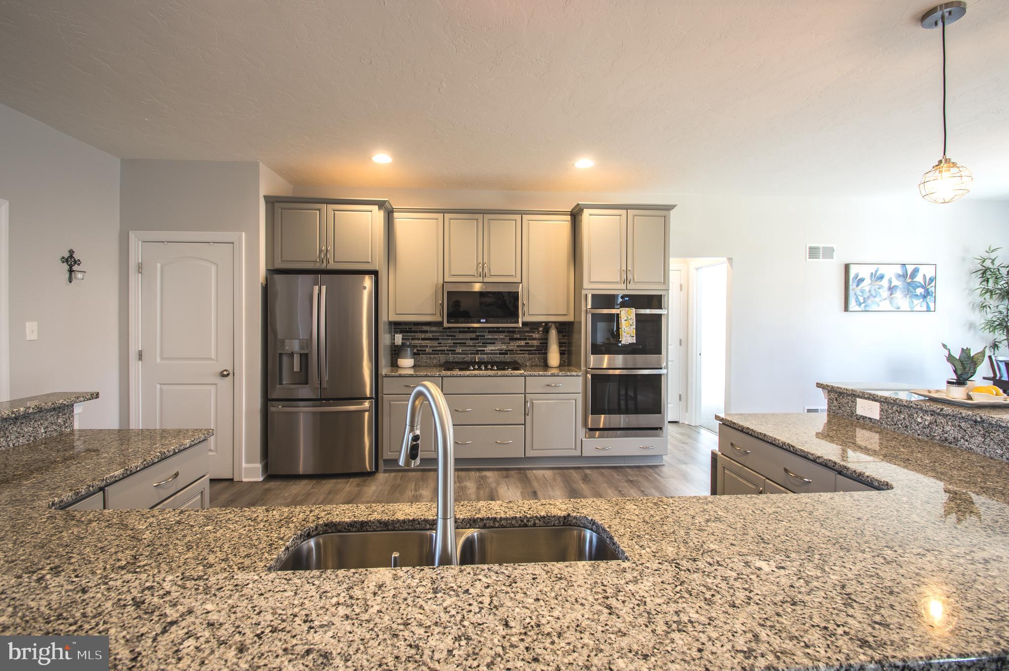 105 Quartz Ridge Road Hanover, PA 17331 - Photo 22 of 51 a kitchen with stainless steel appliances granite countertop a refrigerator and a sink