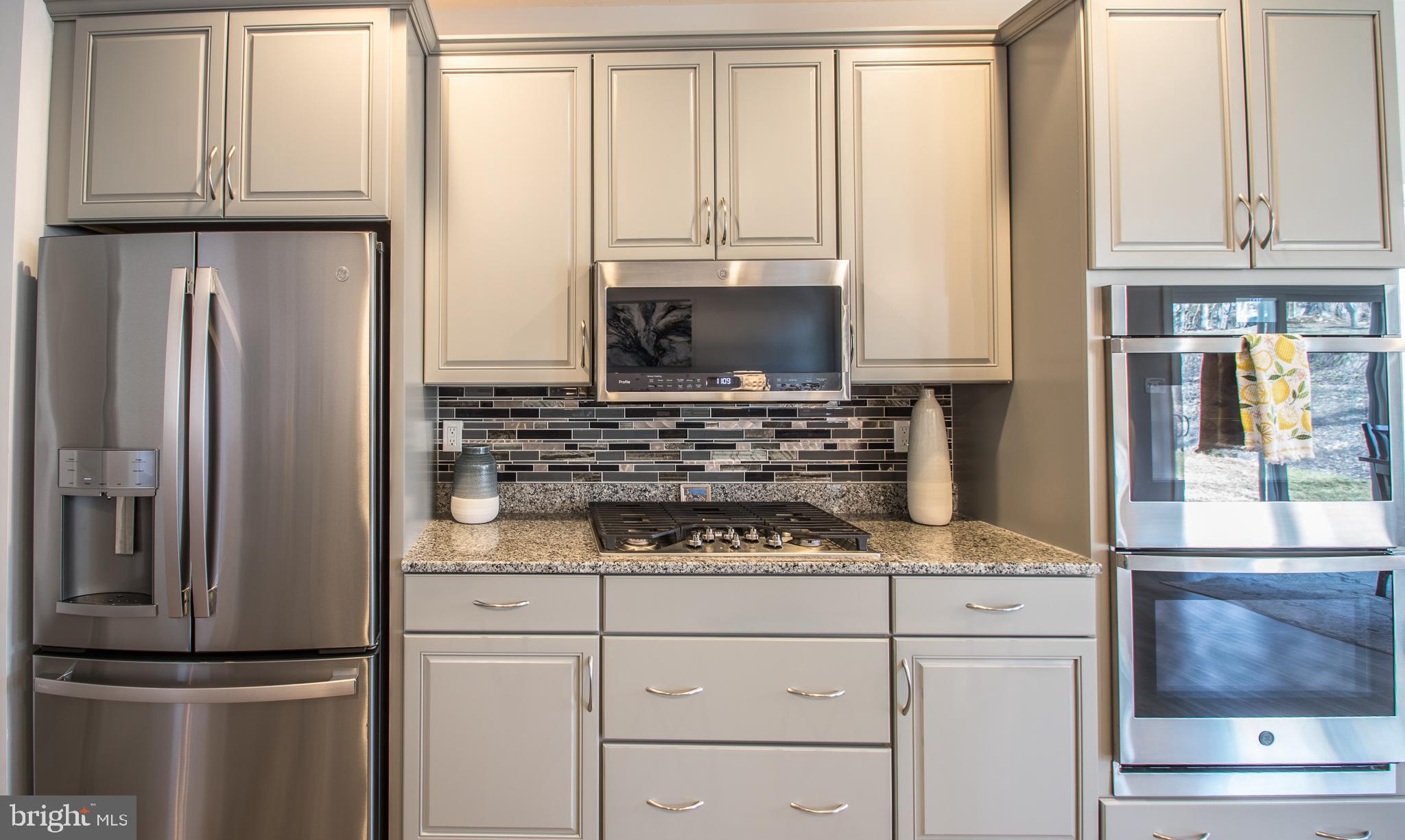 105 Quartz Ridge Road Hanover, PA 17331 - Photo 25 of 51 a kitchen with granite countertop white cabinets and stainless steel appliances