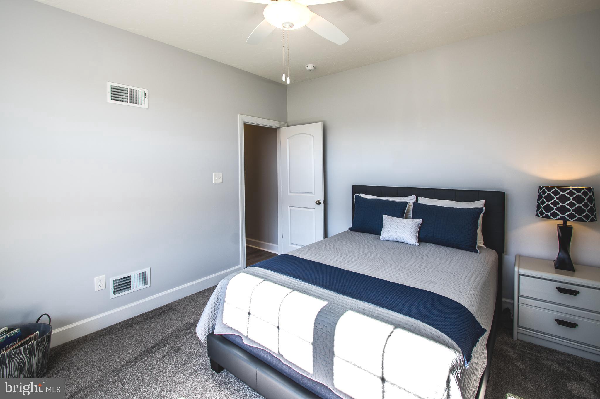 105 Quartz Ridge Road Hanover, PA 17331 - Photo 36 of 51 a bedroom with a bed and a chandelier