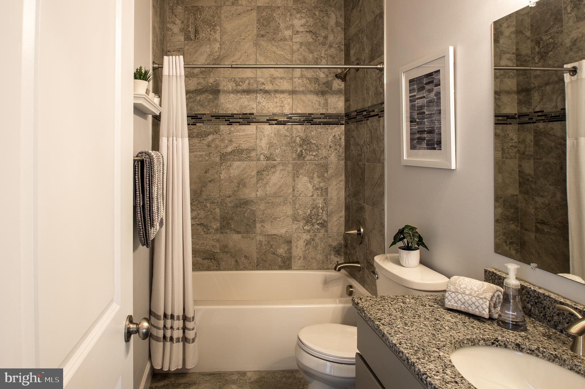 105 Quartz Ridge Road Hanover, PA 17331 - Photo 38 of 51 a bathroom with a granite countertop bathtub toilet and shower