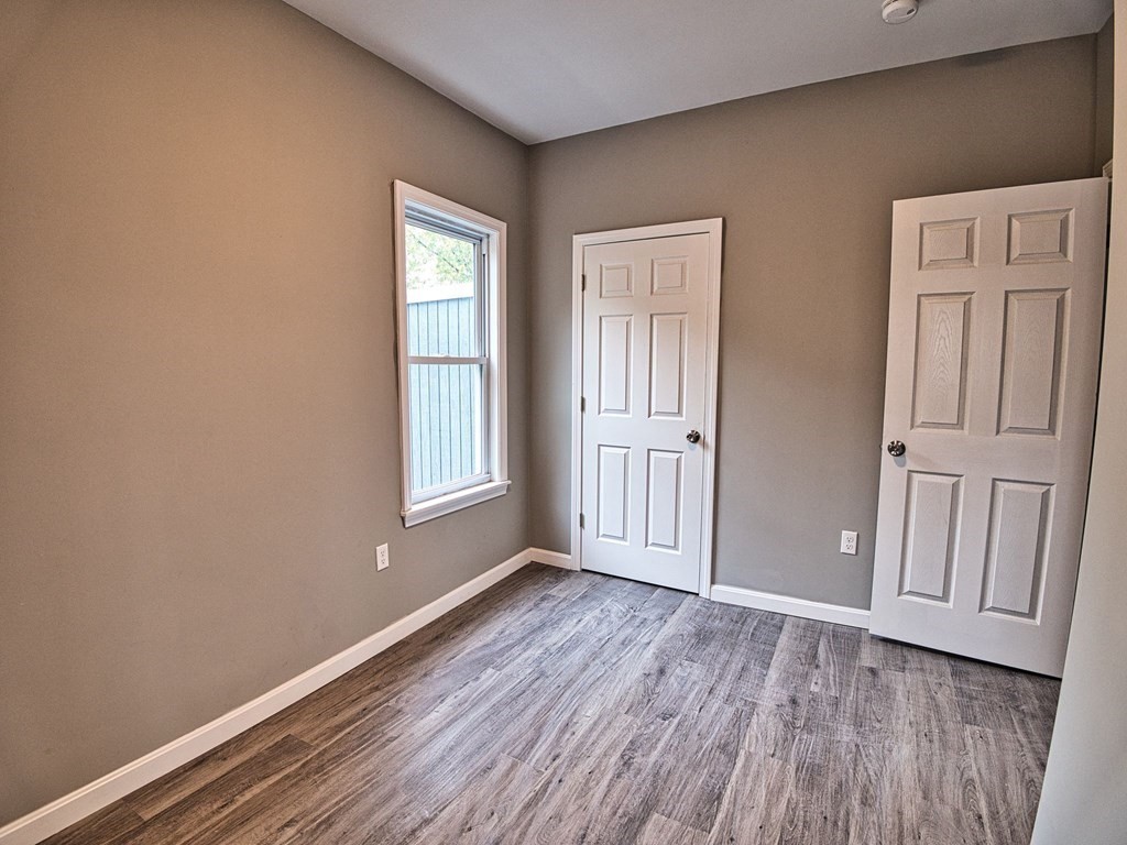 62 Bay Street Fall River, MA 02721 - Photo 11 of 21 a view of an empty room with wooden floor and window