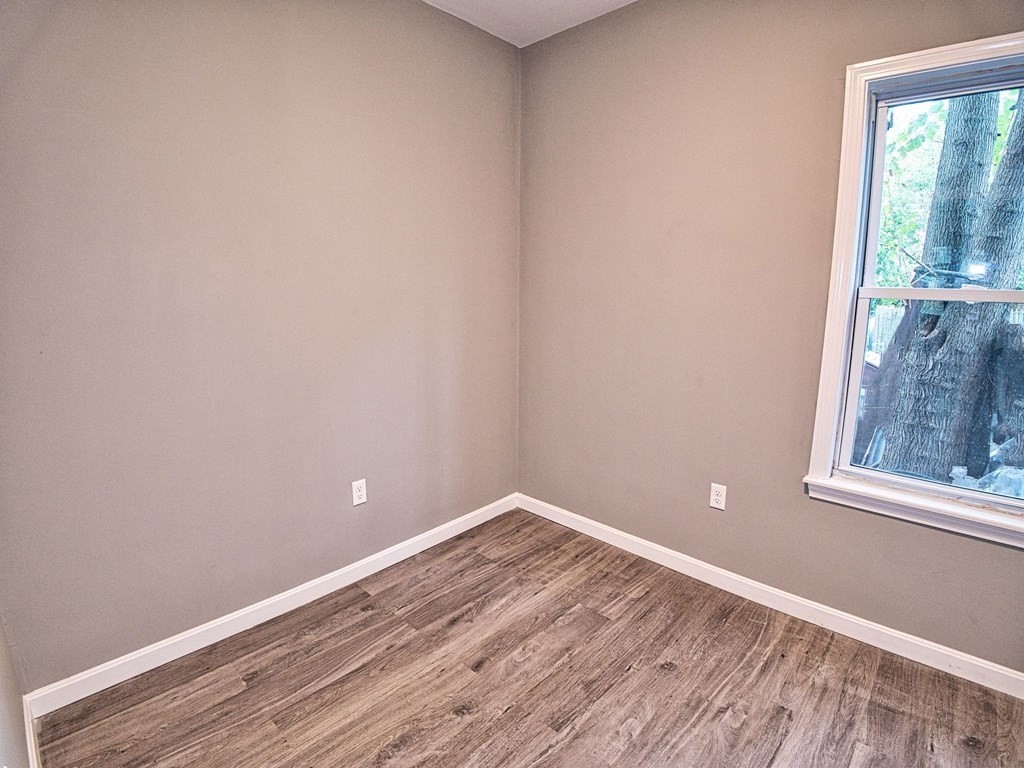 62 Bay Street Fall River, MA 02721 - Photo 13 of 21 a view of empty room with wooden floor and fan