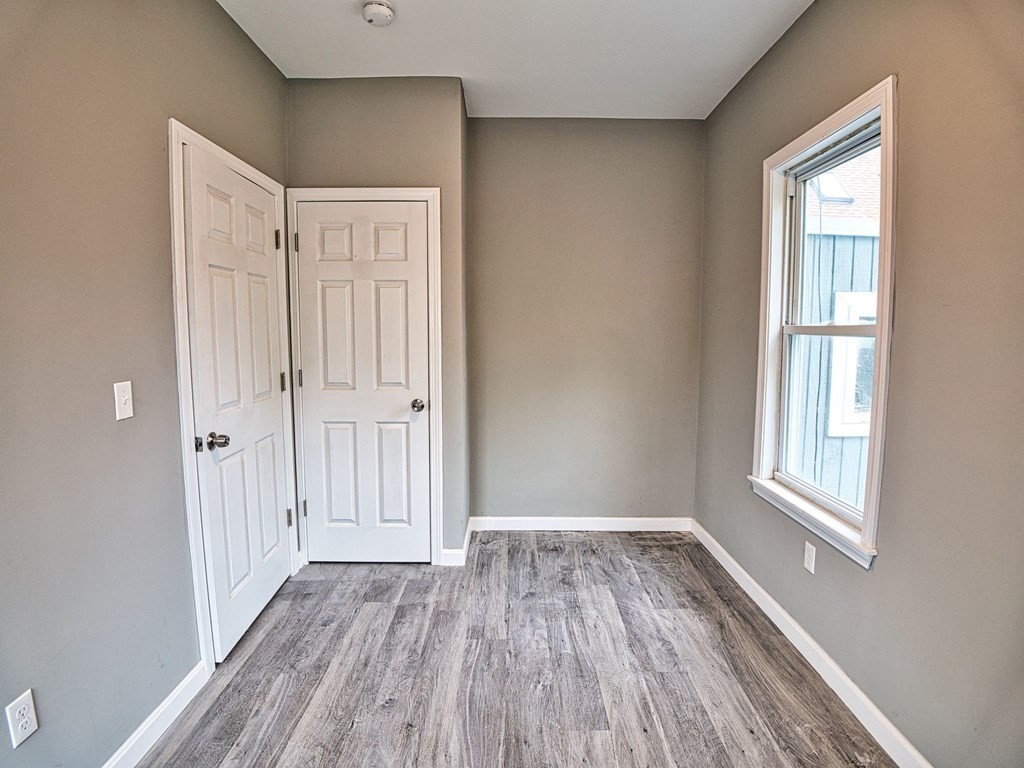 62 Bay Street Fall River, MA 02721 - Photo 15 of 21 a view of an empty room with wooden floor and a window