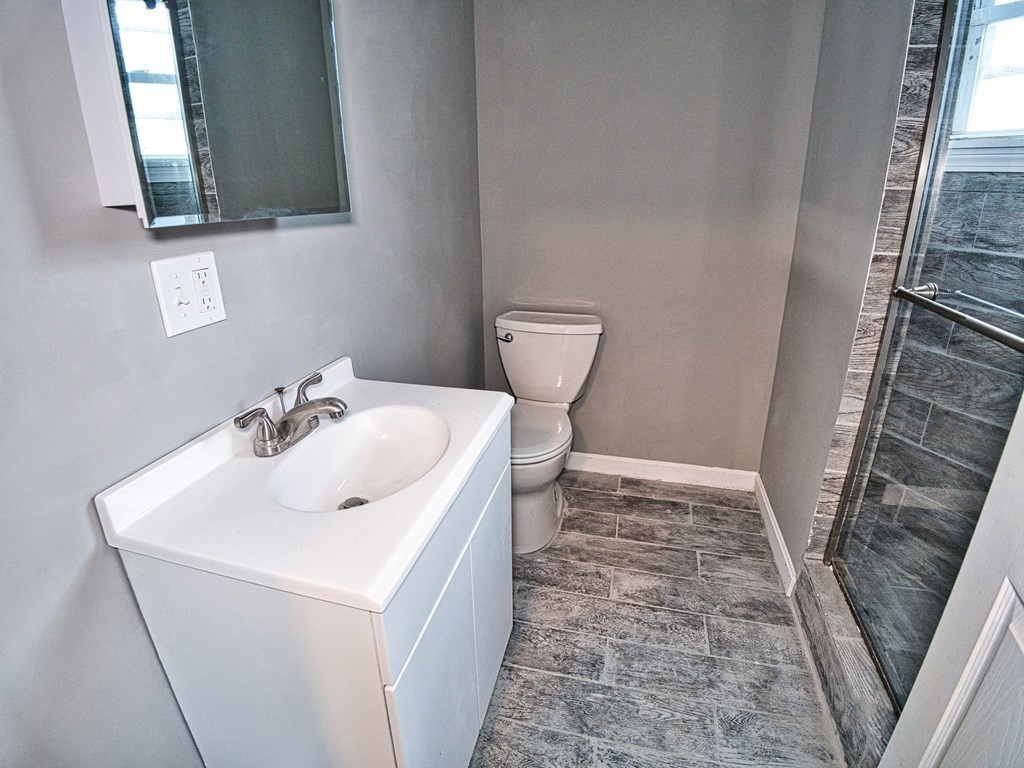 62 Bay Street Fall River, MA 02721 - Photo 16 of 21 a bathroom with a sink toilet and mirror